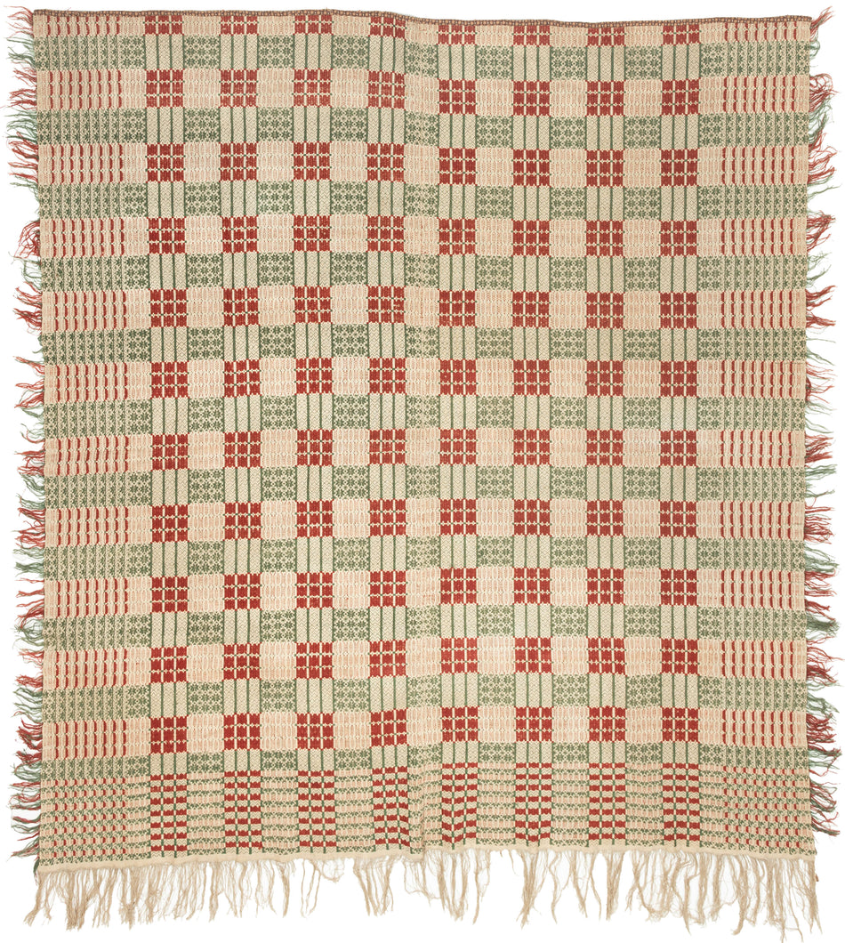 Overshot American Coverlet a grid of squares that utilize red and green wefts over an exposed white warp to create various patterns including stripes, diamonds and snowflakes. The grid is surrounded by a border of thin patterning on three sides. The top unbordered section is seamed with cloth indicating the original coverlet was likely longer.The addition of borders showcase the weaver's proficiency and skill. Fine weaving and wonderful contrast give this a crisp feel and eye dazzling visual effect.