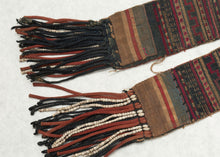  This vintage textile was crafted by the Loimi Akha Hill Tribe near the border of Myanmar and Thailand.

The Akha hill tribe people live in China, Myanmar, Thailand, Laos, and Vietnam. They practice a belief system that has strong symbiotic relationship with the land and is infused with animism and ancestor worship among traditions and rituals.job's tear traditional costume of the Akha people. It features a deep indigo ground with lovingly decorated ends in pink, red and ivory cross-stitch