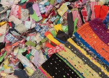 "Cotton and Wool Rag Rug", 2024  Made using recycled fabrics, giving it a distinctive multicolor and shaggy pile. Much of the fabric used features patterning giving the face an explosive feel. The wool wefting on the back of the composition is structured into neat blocks of color offering an excellent&nbsp; juxtaposition to the controlled chaos of the shaggy front. EMMA REDMOND