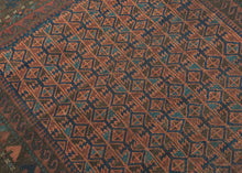 Afghan Baluch tight lattice design in earthy reds, browns, turquoise and apricot. Wide in the center but narrower on the top and bottom giving it a wonky charm. Finished with skirts of multicolor banded kilim on top and bottom.