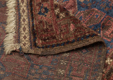 Afghan Timuri baluch It features a pattern jumbled "S" filled polygons in multiple shades of pink and purple on blue ground. Plush silky wool with a dark but lustrous complexion. Finished with kilim edges of latch hooked diamonds