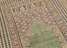 This Ghoirdes rug was woven in Western Anatolia during the 19th century  It features open and undulating sage mihrab with beautiful red and white flowers blossoming against a sky blue ground in it's stepped niche. Framed by a main border of simple yet sensational brown and white stripes. Beautifully drawn and perfectly balanced with a soft and calming palette of desirable tones. A rug which is both highly decorative and highly collectible at the same time.