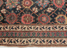 This rug was handwoven in Veramin during the early 20th century.

It features a classic mina khani design in a wide array of tones including red, pink, blue, green, purple and yellow which really pop against the deep&nbsp;surmah&nbsp;or blue/black ground. Uncharacteristically, a red and blue Laleh Abbasi pattern is utilized for the main border and flanked by ivory ground minor borders. Laleh Abbasi patterning is almost always used as a guard border around the perimeter of a rug. Other unique details include