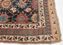 This rug was handwoven in Veramin during the early 20th century.

It features a classic mina khani design in a wide array of tones including red, pink, blue, green, purple and yellow which really pop against the deep&nbsp;surmah&nbsp;or blue/black ground. Uncharacteristically, a red and blue Laleh Abbasi pattern is utilized for the main border and flanked by ivory ground minor borders. Laleh Abbasi patterning is almost always used as a guard border around the perimeter of a rug. Other unique details include