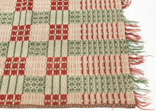 Overshot American Coverlet a grid of squares that utilize red and green wefts over an exposed white warp to create various patterns including stripes, diamonds and snowflakes. The grid is surrounded by a border of thin patterning on three sides. The top unbordered section is seamed with cloth indicating the original coverlet was likely longer.The addition of borders showcase the weaver's proficiency and skill. Fine weaving and wonderful contrast give this a crisp feel and eye dazzling visual effect.