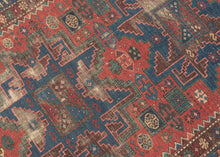 This Shirvan rug was woven in the Caucasus during the late 19th century.

It features three powerful leshgi stars on an earthy red ground full of various rosettes and protection symbols.&nbsp; Encapsulated by multiple individualized borders including rosettes, sunbursts, and calyx and serrated leaves. A very handsome palette of blues, reds, greens and aubergine is accentuated by glowing coral and orange among other tones.