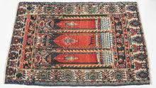 This Senneh rug was woven during the second quarter of the 20th Century.

Wonderful but still folky perspective of looking into a building with three arches each with a hanging lantern. The perspective is accentuated by a grid which runs into a columned platform before breaking off into the glowing red distance. The piece is further differentiated by the addition of a zoomorphic alter directly in the center.