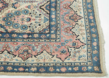 This Sarouk was handwoven during the middle of the 20th century.

The composition is composed of various weeping willows and floral bouquets in a pleasing palette of blues, reds and pinks on a pale yellow ground. This patterning is uncharacteristic of Sarouk weaving and more commonly associated with Kashan. Nicely framed by a distinctive red and yellow dual ground interlock border.