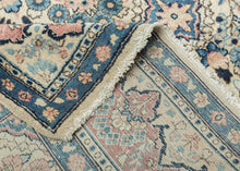 This Sarouk was handwoven during the middle of the 20th century.

The composition is composed of various weeping willows and floral bouquets in a pleasing palette of blues, reds and pinks on a pale yellow ground. This patterning is uncharacteristic of Sarouk weaving and more commonly associated with Kashan. Nicely framed by a distinctive red and yellow dual ground interlock border.