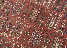 This Shirvan was handwoven during the early 20th century in the Eastern Caucasus.

It features an allover design in diagonal rows on an earthy red ground.&nbsp;The field is composed of tree-like forms each surrounded by rosettes. In between each tree-like form are a geometric flower and a form with opposing bird-like figures.