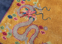 This Art&nbsp;Deco rug was handwoven in Tientsin, China during the second quarter of the 20th century.&nbsp;

This Deco rug features a central dragon surrounded by additional dragons in each of it's four corners all atop an open golden yellow ground framed by a thick unadorned navy border. The scaly and serpentine dragons come in a variety of tones and are each surrounded by colorful cloudbands which emphasize that they are in flight. In China the dragon is often depicted winglessly flying through clouds. I