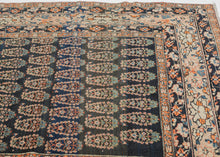 This Tabriz rug was handwoven during the early 20th century.

It features an all-over design of penguin-like&nbsp;botehs&nbsp;waddling row by row in alternating directions. The botehs shift slightly in proportion and placement giving the composition a wavy feel. Adding to the funky feel and nature of the rug the weaving style begins to change near the top from a crisper weave to a looser one while the colors used slowly begin to shift as the new weaver presumably began to run out of the original yarn.&nbsp;