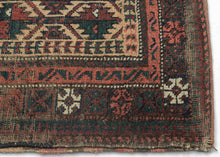 BALUCH BALISHT It features a geometric trellis motif in a variety of earthy reds and deep greens on a camel ground. The Baluch are masters of accomplishing a lot with a limited palette most often with the strategic use of white as us seen in the borders. This balisht has it's original kilim back still intact and which employs thick stripes of reds, blues, brown and purple.