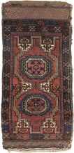 This&nbsp;Baluch rug was handwoven during the early 20th century in Afghanistan.

It features two octagonal Turkmen guls on a red ground and framed by a border of hourglass and cruciform shapes. Rich saturated tones and nice interplay between light and dark. It has original kilim ends on top and bottom that are each embellished with their own weft float pattern. This balisht has it's original kilim back still intact and which employs thick stripes of red, orange, brown and ivory.