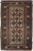 BALUCH BALISHT It features a geometric trellis motif in a variety of earthy reds and deep greens on a camel ground. The Baluch are masters of accomplishing a lot with a limited palette most often with the strategic use of white as us seen in the borders. This balisht has it's original kilim back still intact and which employs thick stripes of reds, blues, brown and purple.