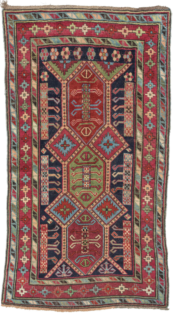 This rug was woven in the Karabagh region of the South Caucasus during the late 19th century.   Itt features a powerful all design of angular shapes on a deep navy ground. Framed by a main border of geometric plus shaped rosettes sandwiched between two 