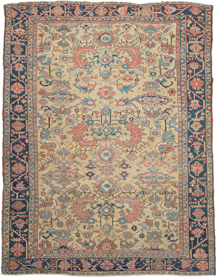 This classic Heriz features an all-over design of geometric flowers and energetic serrated leaves. Rendered in vibrant jewel tones with reds, coral, ivory, brown and four different blues on a rare and elegant gold ground. The meaty and full pile give the masterfully dyed wool more saturation and the rug a stronger presence. It is framed by a main border of large alternating palmettes. A real stunner!