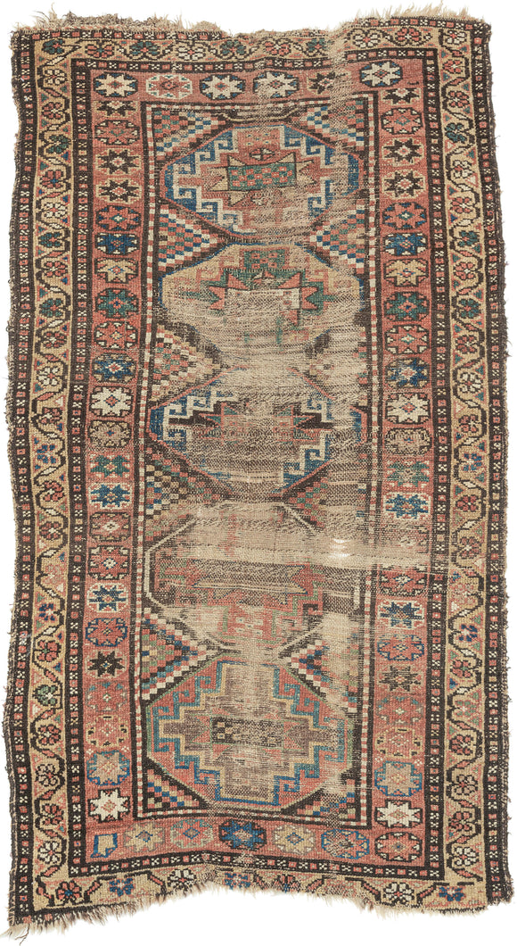 This Kurdish rug was handwoven during the late 19th century.

It features a weathered pattern of polygons filled with memling guls and surrounded by an inner border of eight pointed stars and an outer floral meander border. Wonky village weave with all natural dyes and hearty wool. The wear showcases the rugs use over more than a century and celebrates it materiality by exposing the handspun warps and wefts.