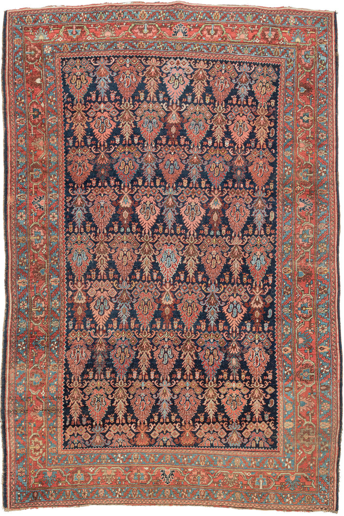 This Bidjar rug was handwoven during the early 20th century (1925-1950) in Northwest Iran.  It features an all-over design of polychrome forms reminiscent of cypress trees in various reds, blues, yellows and pinks on a deep navy ground. Each tree form is filled with a trio of botehs at its center. Framed by a rich red main border that is flanked by energetic turquoise minor borders that pull turquoise accents from the field and invigorate the whole composition.