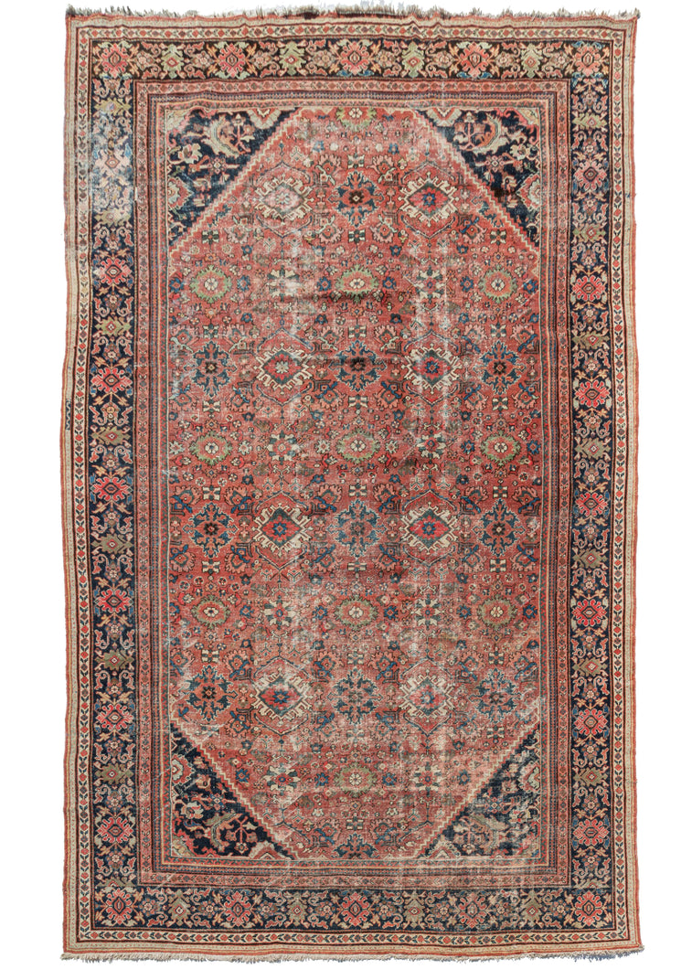 Antique Palace sized Mahal rug an all over pattern of various palmettes in greens, blues, coral and ivory on a brick-red field. The field and cornice design appears to be influenced by the classic herati design. The main border is also composed of a palmette motif, on a surmah ground. Various distinct minor borders add interesting detail and interest to the piece.