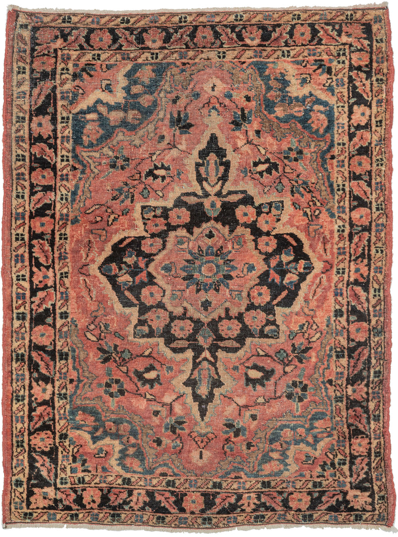 It features of an deep navy central medallion on a crimson ground. The field is filled with fine floral sprays and balanced by four scalloped cornices woven in light blue. The border is composed of a straightforward floral meander in the same deep navy almost black ground of the central medallion. SAROUK PAIR