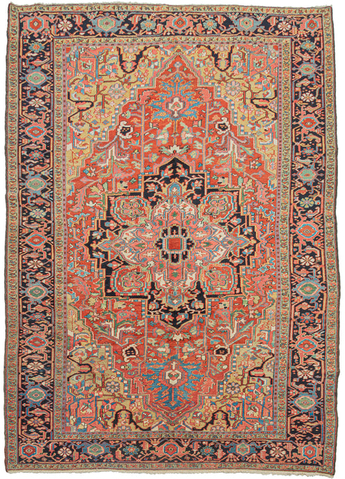 This classic Heriz features a geometric central medallion with vibrant jewel tones and meaty wool. A tomato-red field is complemented by deep navy, powder blue, green, gold, coral, and ivory. The four golden cornices add elegance to the rug and wonderful jewel tones& add vibrancy to the composition