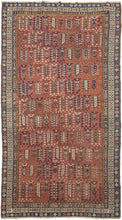 This Shirvan was handwoven during the early 20th century in the Eastern Caucasus.

It features an allover design in diagonal rows on an earthy red ground.&nbsp;The field is composed of tree-like forms each surrounded by rosettes. In between each tree-like form are a geometric flower and a form with opposing bird-like figures.