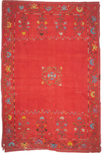 This Suzani was handmade during the early 20th century in Uzbekistan.

This suzani is composed of central floral motif embroidered in silk on an open red cotton field. Flanked by vibrant multi-tiered blossoming flowers to the right and left and framed by a lively floral meander. A multitude of colors are used for the embroidery, including turqoise, green, white, yellow, and purple.