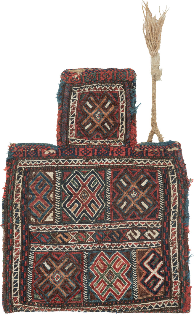 Luri namkadan saltbag soumak woven face with a pattern of bur-like protection symbols in two rows and on the neck of the bag. The top row breaks off to the left mid symbol while the bottom breaks off to the right mid bur giving the composition the illusion of movement. The pattern is simple yet complex with rich and saturated blues, reds, green, and apricot with chocolate brown and a bright white that really pops. The white is achieved by using cotton and can be seen on back of the bag 