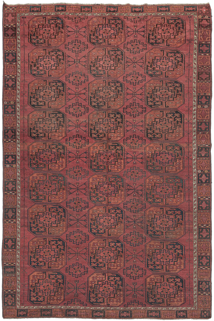 This Ersari Turkmen rug was woven during the first quarter of the 20th century in Northern Afghanistan.  It features a traditional Ersari gül design with a soft palette of orange and indigo on an earthy madder red ground with accents of natural undyed brown and ivory wool. The more skeletal secondary güls are nice complement to the fuller main guls and give the field a more open feel.