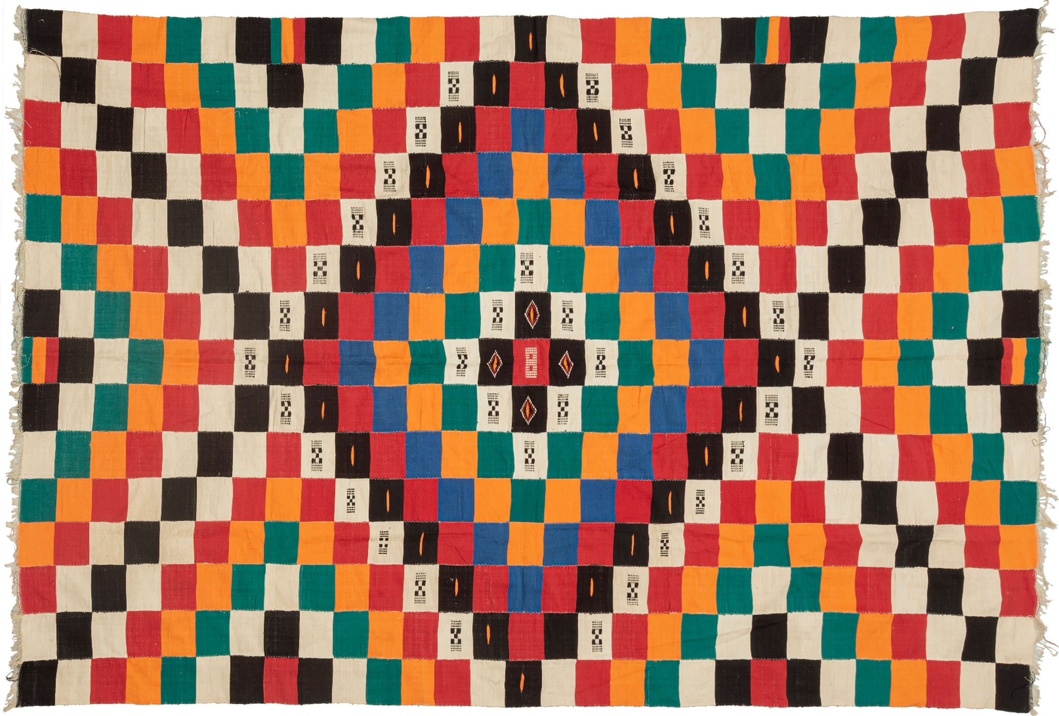 This blanket was likely woven by the Fulani people in Mali during the middle of the 20th century.

It was woven in multiple stripes which have been attached horizontally. It features an eye dazzling checkerboard composed of white, black, red, green, blue and a sunny yellow-orange. Four individual squares around the perimeter are woven with the red-yellow-green tricolor of the Malian flag.

Via The Metropolitan Museum of Art The checkerboard, a basic West African composition, ultimately may derive from