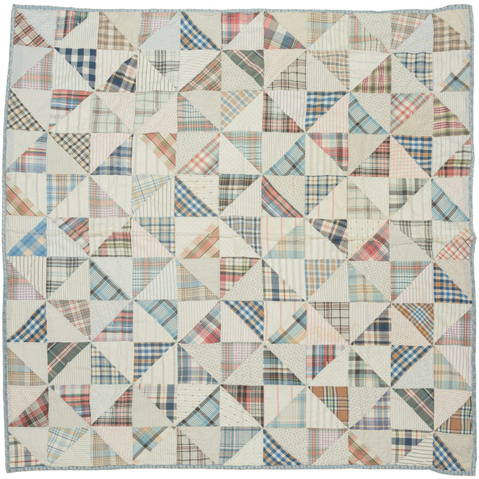 This vintage patchwork quilt was crafted in North America during the middle of the 20th century.


It features patch-worked grid composed of squares. Each square is formed of well balanced triangles of either colorful flannel patterns or more open dotted and striped cream ground patterning. The squares have been pieced together wondefully and the composition can be read many different ways that is accentuated by its perfectly square dimensions.