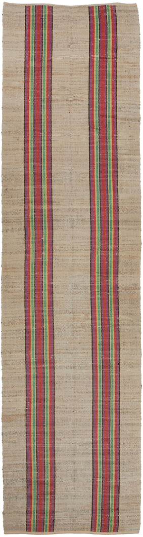 North American antique Rag Rug runner featuring two bright stripes along the length of the rug in pink, yellow, green, purple, and navy. The pop of color against the light tan field is invigorating.