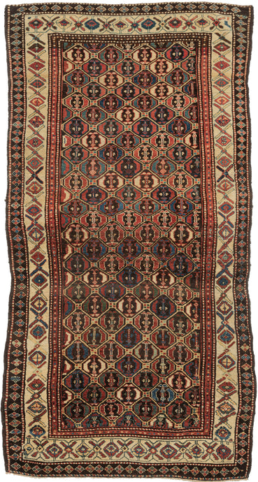 This Lori rug was handwoven during the late 19th century.   It features a lovely diamond lattice design which both well executed but also with the right amount of wonkiness to give it some personality. Rendered in lush wool an a vibrant red, blue, yellow and green with brown and ivory accents. The main border of 