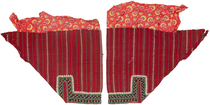 These trouser cuffs were handmade in Turkmenistan during the 20th Century.   Turkmen women traditionally wear colorful ankle length dresses with baggy trousers in contrasting color and decorated bands. These trousers feature wonderful detailed embroidery bands near the ankles in blue, red, orange, green and ivory on a striped magenta cloth. The backing floral print cloth is visible.