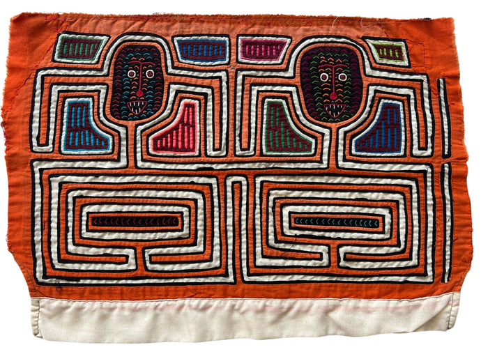 Vintage Mola cloth handmade by the Guna (previously spelled Kuna) people of the San Blas Islands.  Mola is a reverse appliqué technique, similar to the technique used in quilting but using multiple layers of different-colored cloth that are first sewn together before a design is created by cutting away different layers. These cloths are traditionally made in pairs to be worn on the front and back of women's blouses.  This Mola features what may be two abstracted human forms.