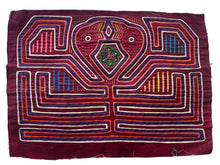 Vintage Mola cloth handmade by the Guna (previously spelled Kuna) people of the San Blas Islands.  Mola is a reverse appliqué technique, similar to the technique used in quilting but&nbsp;using multiple layers of different-colored cloth that are first sewn together before a design is created by cutting away different layers. These cloths are traditionally made in pairs to be worn on the front and back of women's blouses.  This Mola features a two confronting bird heads.  