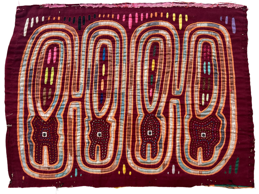 Vintage Mola cloth handmade by the Guna (previously spelled Kuna) people of the San Blas Islands.  Mola is a reverse appliqué technique, similar to the technique used in quilting but using multiple layers of different-colored cloth that are first sewn together before a design is created by cutting away different layers. These cloths are traditionally made in pairs to be worn on the front and back of women's blouses.  This Mola features four abstracted crocodiles.