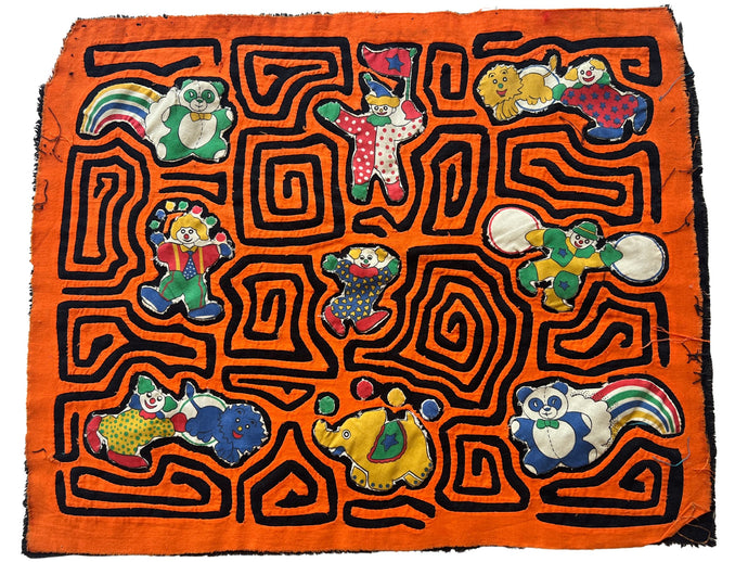 Vintage Mola cloth handmade by the Guna (previously spelled Kuna) people of the San Blas Islands.  Mola is a reverse appliqué technique, similar to the technique used in quilting but using multiple layers of different-colored cloth that are first sewn together before a design is created by cutting away different layers. These cloths are traditionally made in pairs to be worn on the front and back of women's blouses.  This Mola features a variety of clowns and circus animals. 