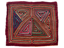 Vintage Mola cloth handmade by the Guna (previously spelled Kuna) people of the San Blas Islands.  Mola is a reverse appliqué technique, similar to the technique used in quilting but&nbsp;using multiple layers of different-colored cloth that are first sewn together before a design is created by cutting away different layers. These cloths are traditionally made in pairs to be worn on the front and back of women's blouses.  This Mola features a geometric design on a burgundy ground. 