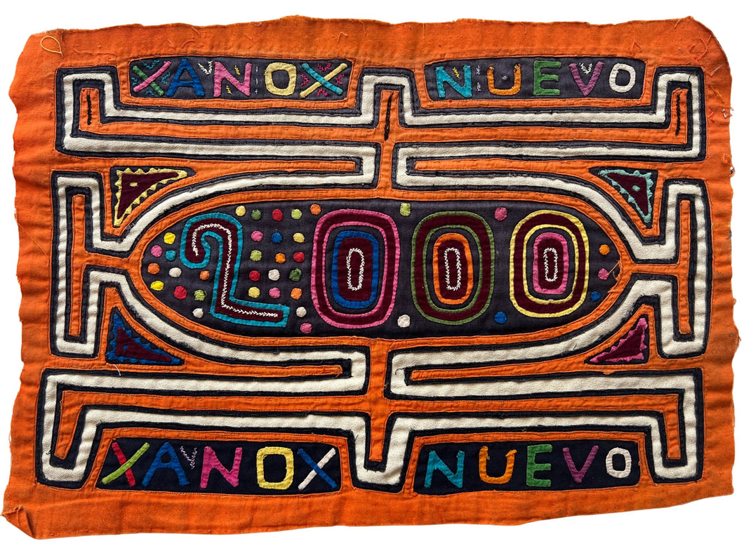 Vintage Mola cloth handmade by the Guna people of the San Blas Islands.  Mola is a reverse appliqué technique, similar to the technique used in quilting using multiple layers of different-colored cloth that are first sewn together before a design is created by cutting away different layers. These cloths are traditionally made in pairs to be worn on the front and back of women's blouses.  This Mola features the words 