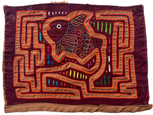 Vintage Mola cloth handmade by the Guna (previously spelled Kuna) people of the San Blas Islands.  Mola is a reverse appliqué technique, similar to the technique used in quilting but&nbsp;using multiple layers of different-colored cloth that are first sewn together before a design is created by cutting away different layers. These cloths are traditionally made in pairs to be worn on the front and back of women's blouses.  This Mola features a colorful fish that almost appears to be jumping in the air.