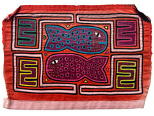 Vintage Mola cloth handmade by the Guna (previously spelled Kuna) people of the San Blas Islands.  Mola is a reverse appliqué technique, similar to the technique used in quilting but&nbsp;using multiple layers of different-colored cloth that are first sewn together before a design is created by cutting away different layers. These cloths are traditionally made in pairs to be worn on the front and back of women's blouses.  This Mola features speckled fish