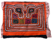 Vintage Mola cloth handmade by the Guna (previously spelled Kuna) people of the San Blas Islands.  Mola is a reverse appliqué technique, similar to the technique used in quilting but&nbsp;using multiple layers of different-colored cloth that are first sewn together before a design is created by cutting away different layers. These cloths are traditionally made in pairs to be worn on the front and back of women's blouses.  This Mola features a psychedelic pattern of confronting bird heads. 