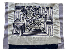 Vintage Mola cloth handmade by the Guna (previously spelled Kuna) people of the San Blas Islands.  Mola is a reverse appliqué technique, similar to the technique used in quilting but&nbsp;using multiple layers of different-colored cloth that are first sewn together before a design is created by cutting away different layers. These cloths are traditionally made in pairs to be worn on the front and back of women's blouses.  This Mola features a bird created from lilac and white fabric.  