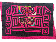 Vintage Mola cloth handmade by the Guna (previously spelled Kuna) people of the San Blas Islands.  Mola is a reverse appliqué technique, similar to the technique used in quilting but&nbsp;using multiple layers of different-colored cloth that are first sewn together before a design is created by cutting away different layers. These cloths are traditionally made in pairs to be worn on the front and back of women's blouses.  This Mola features two pairs of confronting birds heads. 