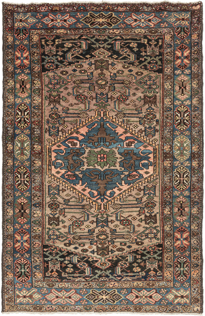 This Serab rug was woven at the end of the 20th century.   It features a central medallion of indigo, green and glowing coral atop a camel herati inspired camel field and midnight cornices. Nicely framed by a main border of floral motifs on an indigo ground and two minor borders of meandering rosettes. 