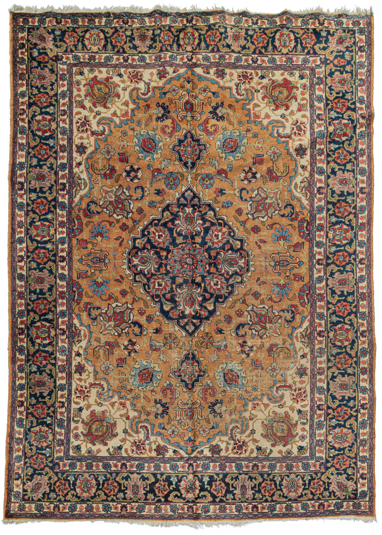 Mid century Tabriz rug featuring a navy central medallion with two teardrop medallions on a burnt orange field of crisp palmettes.  The ivory cornices and minor borders brighten the composition and highlight the shape of the field while the navy border both balance the medallion and frames the composition well. 