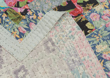 This vintage patchwork quilt was crafted in North America during the middle of the 20th century.


It features patch-worked squares of various fabric in rows of serrated stripes organized on the diagonal. Many of the squares feature there own detailed patterning which adds interest and touch of fun! Much of the stitching has been completed by hand included large visible running stitches in black giving the piece a kantha-like feel.