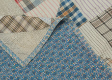 This vintage patchwork quilt was crafted in North America during the middle of the 20th century.


It features patch-worked grid composed of squares. Each square is formed of well balanced triangles of either colorful flannel patterns or more open dotted and striped cream ground patterning. The squares have been pieced together wondefully and the composition can be read many different ways that is accentuated by its perfectly square dimensions.